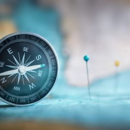 Image of compass and pushpins